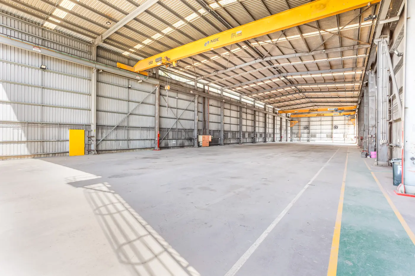 Inside the Main Crane Shed showing overhead gantry cranes and high-clearance workshop bays