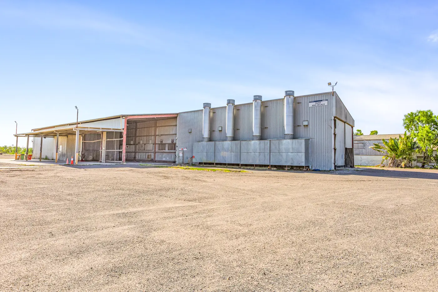 Exterior of the Paint and Blast Facility with extraction stacks and awning